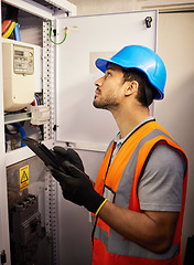 Image showing Tablet, electricity and man with control box for repair, maintenance and inspection for power. Engineering, electrician and male worker on digital tech online for service, construction and labor