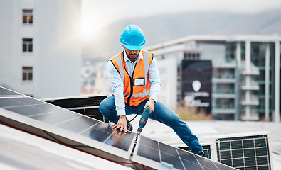 Image showing Technician man, drill and solar panel on roof with installation, sustainability and construction in city. Engineer, tools and photovoltaic system with building, development or renewable energy in cbd