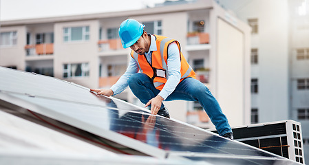 Image showing Technician man, construction and solar panel on roof for maintenance, sustainability or inspection in city. Engineer, check and photovoltaic system for building, industry and renewable energy in cbd