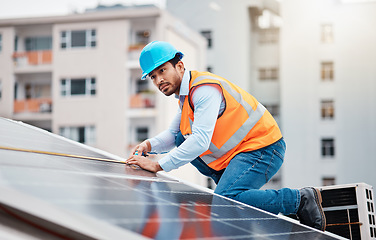 Image showing Technician man, tape and solar panel on roof with thinking, sustainable vision and construction in city. Engineer, tools and photovoltaic system with building, measuring and renewable energy in cbd