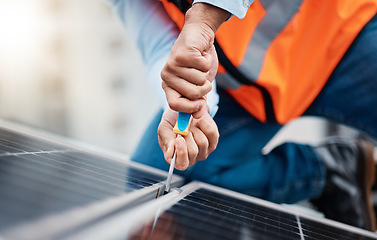 Image showing Solar panels, tool and closeup of male engineer doing maintenance or repairs with screwdriver. Renovation, handyman and zoom of an industrial worker working on eco friendly construction on rooftop.