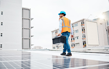 Image showing Solar panel, tool box and electricity with man on roof top for renewable energy, project or power. Construction, engineering or technician with contractor in city for inspection and photovoltaic grid