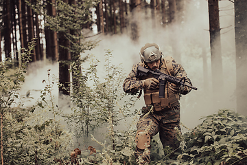 Image showing A modern warfare soldier on war duty in dense and dangerous forest areas. Dangerous military rescue operations