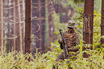 Image showing A modern warfare soldier on war duty in dense and dangerous forest areas. Dangerous military rescue operations