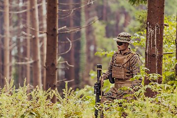 Image showing A modern warfare soldier on war duty in dense and dangerous forest areas. Dangerous military rescue operations