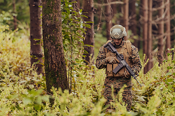 Image showing A modern warfare soldier on war duty in dense and dangerous forest areas. Dangerous military rescue operations