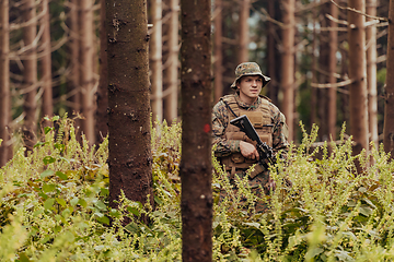 Image showing A modern warfare soldier on war duty in dense and dangerous forest areas. Dangerous military rescue operations