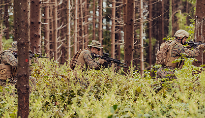 Image showing Modern warfare Soldiers Squad Running as Team in Battle Formation