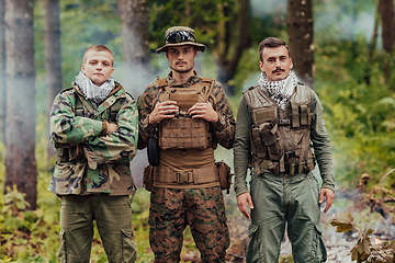 Image showing Group of soldiers in oposit sides celebrating peace after battle