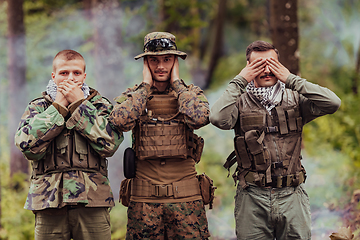 Image showing Group of soldiers in oposit sides celebrating peace after battle by showing blind mute and deaf symbols