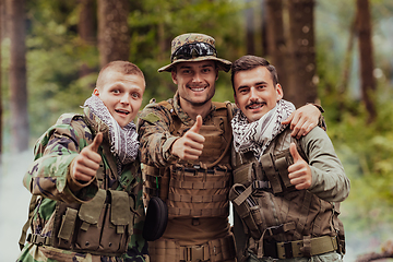 Image showing Group of soldiers in oposit sides celebrating peace after battle