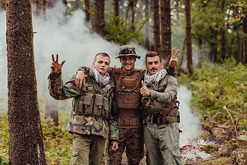 Image showing Group of soldiers in oposit sides celebrating peace after battle