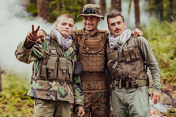 Image showing Group of soldiers in oposit sides celebrating peace after battle