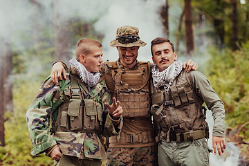 Image showing Group of soldiers in oposit sides celebrating peace after battle