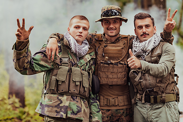 Image showing Group of soldiers in oposit sides celebrating peace after battle