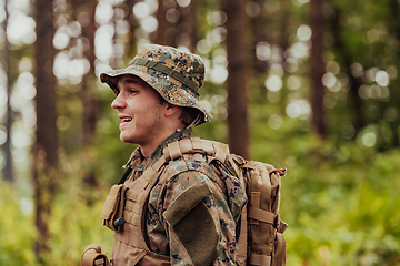 Image showing A modern warfare soldier on war duty in dense and dangerous forest areas. Dangerous military rescue operations