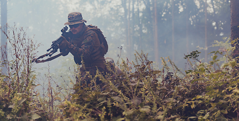 Image showing A modern warfare soldier on war duty in dense and dangerous forest areas. Dangerous military rescue operations