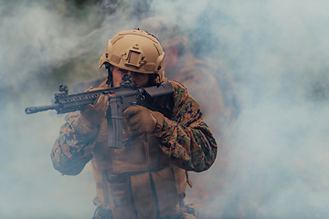 Image showing A soldier fights in a warforest area surrounded by fire