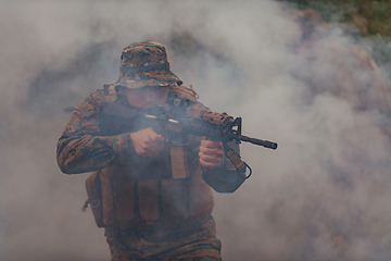 Image showing A soldier fights in a warforest area surrounded by fire