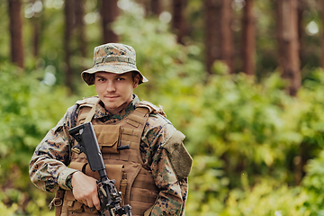 Image showing A modern warfare soldier on war duty in dense and dangerous forest areas. Dangerous military rescue operations