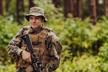 Image showing A modern warfare soldier on war duty in dense and dangerous forest areas. Dangerous military rescue operations