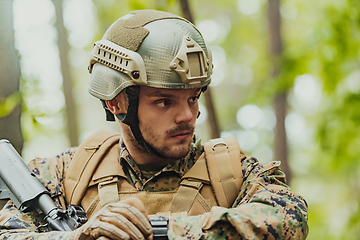 Image showing American marine corps special operations soldier preparing tactical and commpunication gear for action battle closeup