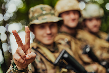 Image showing Soldier fighters standing together with guns. Group portrait of US army elite members, private military company servicemen, anti terrorist squad