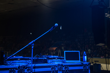 Image showing microphone in concert hall with blue lights