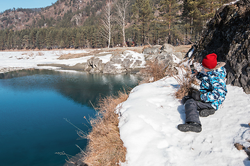 Image showing Young boy taking photos on the coast river