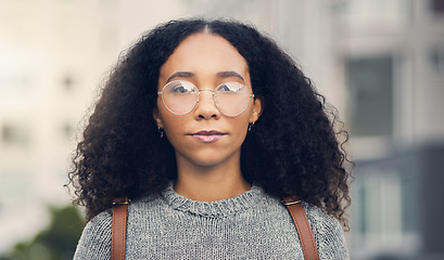 Image showing Serious, confident and portrait of a woman in the city with glasses for eye care or vision. Beautiful, young and headshot of young female person from Mexico exploring an urban town street for travel.