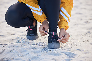 Image showing Beach, closeup and woman tie shoes for an outdoor run for fitness, health and wellness by seaside. Sports, athlete and zoom of female runner tying laces for a cardio workout or exercise by the ocean.