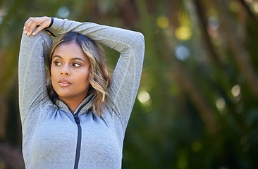 Image showing Nature, fitness and young woman doing a warm up for an outdoor workout or training. Sports, happy and female athlete stretching her arms in a park for a running cardio exercise in a green garden.