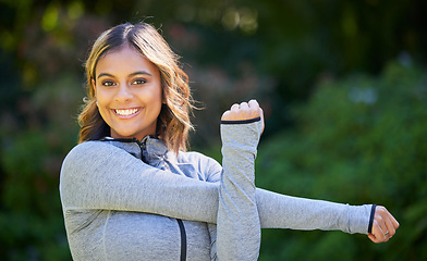 Image showing Nature, sports and portrait of a woman stretching her arms for an outdoor workout or training. Fitness, happy and young female athlete doing a warm up exercise in a park for cardio running in garden.