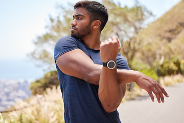 Image showing Thinking, man or runner stretching arms for fitness training, wellness or exercise outdoors on road. Relax, muscle flexibility and healthy Indian male athlete in warm up to start running workout