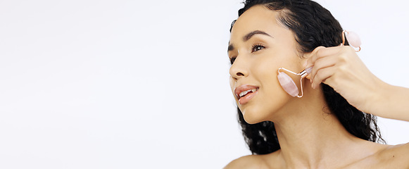 Image showing Black woman, face and beauty with facial roller, skincare routine and natural cosmetics isolated on white background. Dermatology mockup, skin and cosmetic tools, female model hand and rose quartz