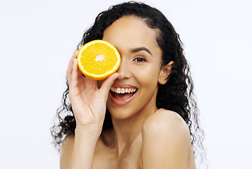 Image showing Orange fruit, skincare and face of woman in studio, clean wellness and white background. Happy model, beauty portrait and citrus fruits for natural detox diet, healthy food and aesthetic dermatology