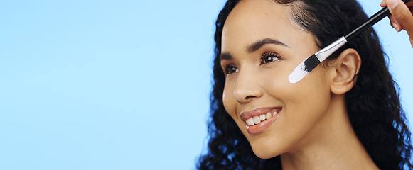 Image showing Woman, face and brush cream for beauty, aesthetic salon and skincare on mockup blue background. Happy studio model, facial lotion and makeup cosmetics for dermatology, collagen and smile of happiness