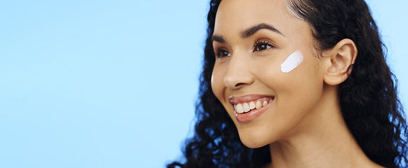 Image showing Woman, face and brush cream for skincare, aesthetic salon and beauty on blue background. Happy studio model, facial lotion and makeup cosmetics for dermatology, collagen mask and smile of happiness