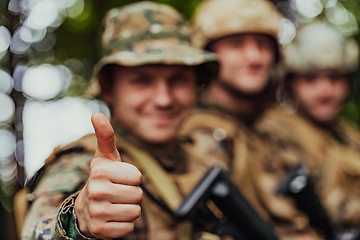 Image showing Soldier fighters standing together with guns. Group portrait of US army elite members, private military company servicemen, anti terrorist squad