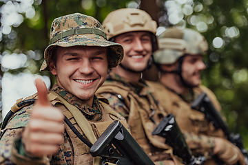 Image showing Soldier fighters standing together with guns. Group portrait of US army elite members, private military company servicemen, anti terrorist squad