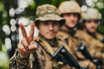 Image showing Soldier fighters standing together with guns. Group portrait of US army elite members, private military company servicemen, anti terrorist squad