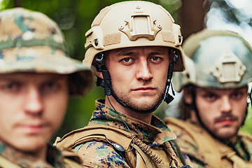 Image showing Soldier fighters standing together with guns. Group portrait of US army elite members, private military company servicemen, anti terrorist squad