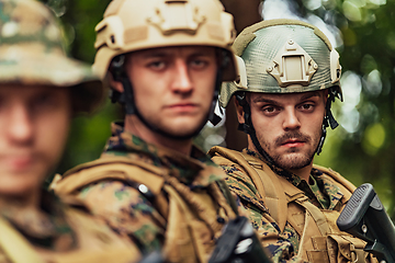 Image showing Soldier fighters standing together with guns. Group portrait of US army elite members, private military company servicemen, anti terrorist squad