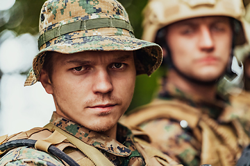 Image showing Soldier fighters standing together with guns. Group portrait of US army elite members, private military company servicemen, anti terrorist squad