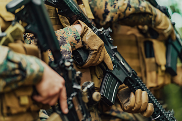 Image showing Soldier fighters standing together with guns. Group portrait of US army elite members, private military company servicemen, anti terrorist squad