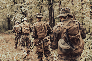 Image showing Modern warfare Soldiers Squad Running as Team in Battle Formation