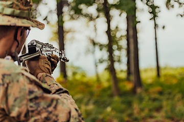 Image showing A modern warfare soldier on war duty in dense and dangerous forest areas. Dangerous military rescue operations