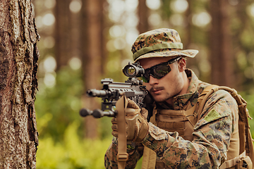 Image showing A modern warfare soldier on war duty in dense and dangerous forest areas. Dangerous military rescue operations