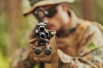 Image showing A modern warfare soldier on war duty in dense and dangerous forest areas. Dangerous military rescue operations