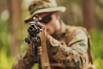 Image showing A modern warfare soldier on war duty in dense and dangerous forest areas. Dangerous military rescue operations